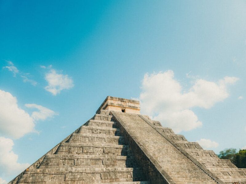Quetzalcoatl: Die gefiederte Schlange als Gott – Die ikonische Pyramide El Castillo von Chichen Itza unter strahlend blaue…