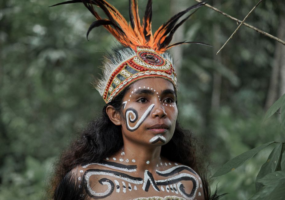 Mehinaku: Frauen am Xingu – Kultur, Rituale und Forschung – Eine Frau in Stammeskleidung mit Gesichtsbemalung inmitten ein…